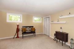 Yellow basement design with black bench